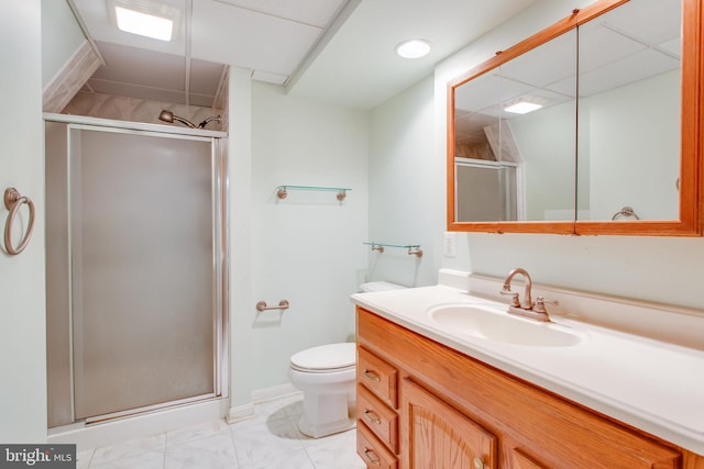 bathroom featuring vanity, toilet, and a shower with shower door