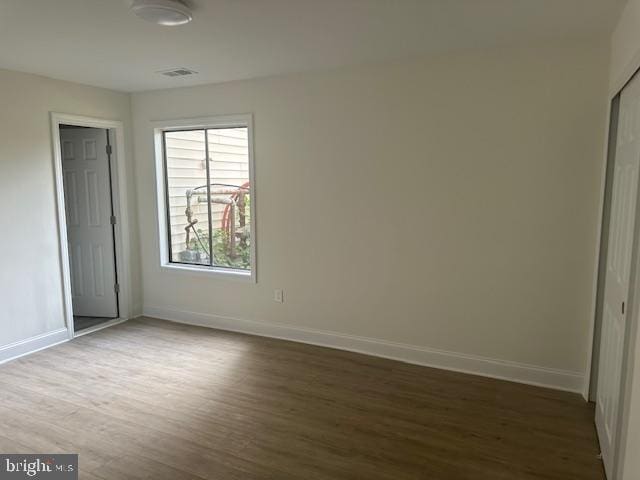 unfurnished bedroom with dark hardwood / wood-style floors