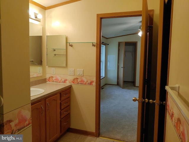 bathroom with vanity, ceiling fan, and crown molding