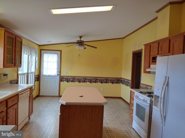 kitchen with ceiling fan, a kitchen island, and white appliances