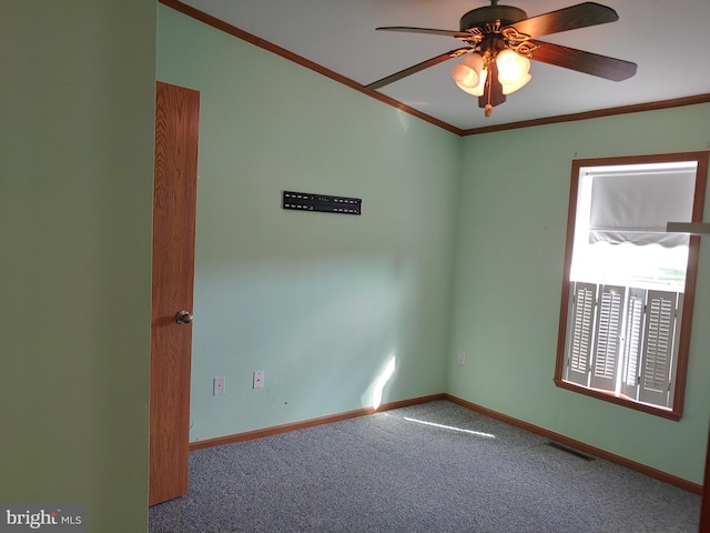 carpeted spare room with ceiling fan and ornamental molding