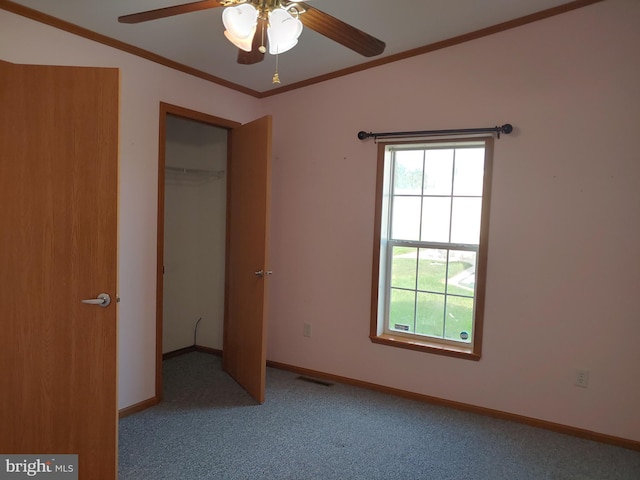 unfurnished bedroom with ceiling fan, crown molding, light carpet, and a closet