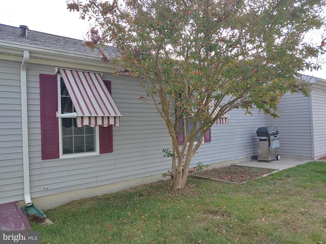 view of home's exterior with a yard