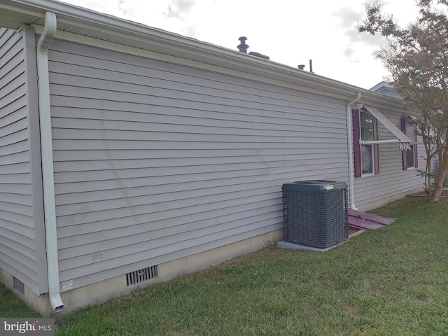 view of home's exterior with central AC unit and a lawn