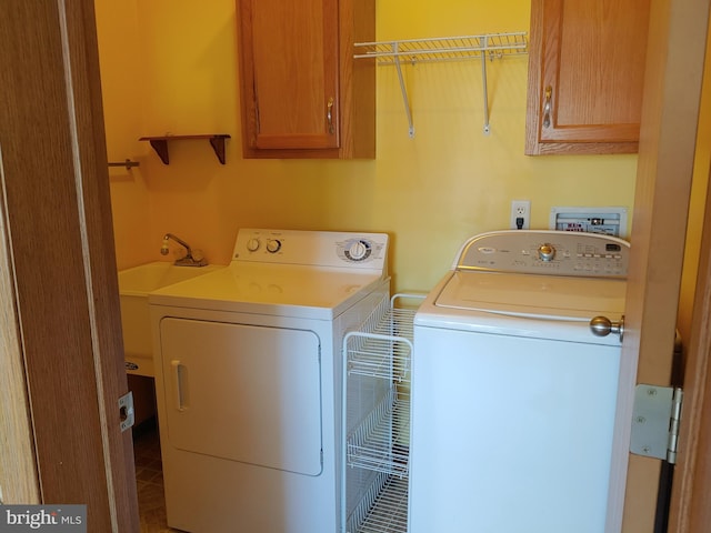 laundry room with cabinets and washing machine and dryer