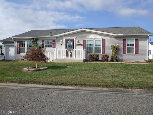 view of front of property featuring a front lawn and a garage