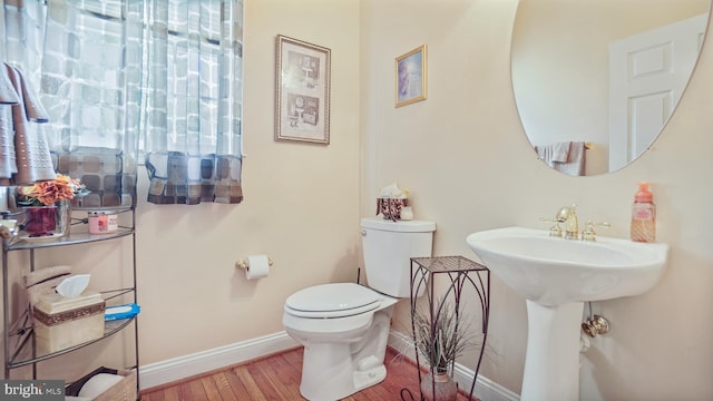 bathroom featuring toilet and hardwood / wood-style flooring