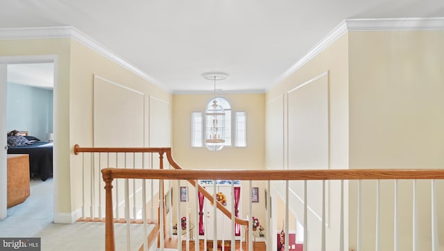 corridor featuring crown molding and light colored carpet