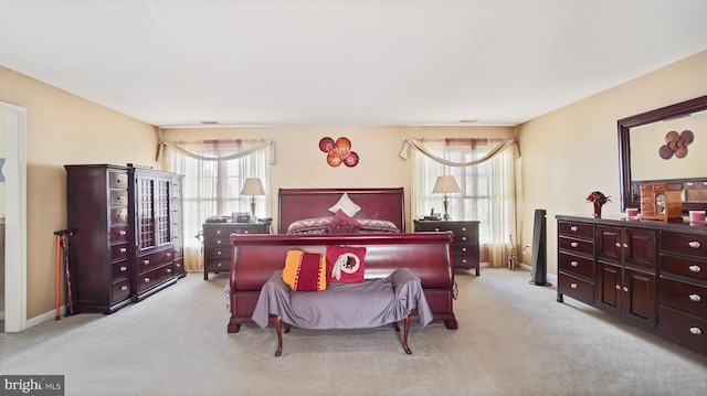 carpeted bedroom featuring multiple windows