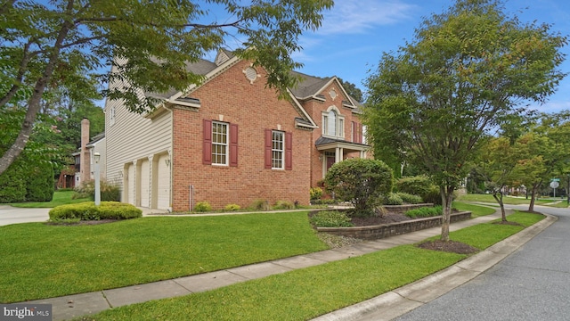 view of property with a front yard and a garage