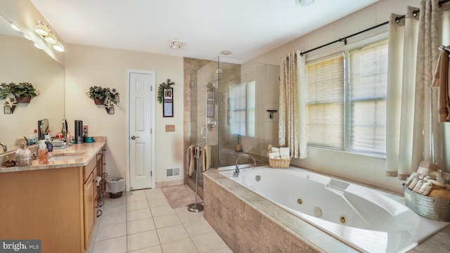 bathroom with vanity, a healthy amount of sunlight, independent shower and bath, and tile patterned floors