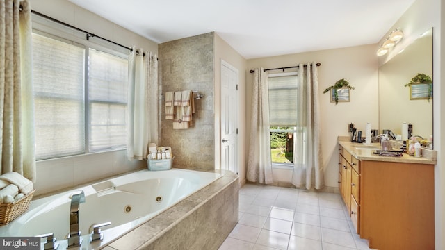 bathroom featuring vanity, tiled tub, and tile patterned floors