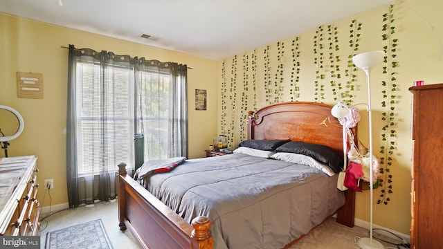 bedroom with light colored carpet