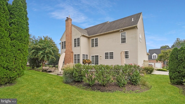 rear view of house with a yard