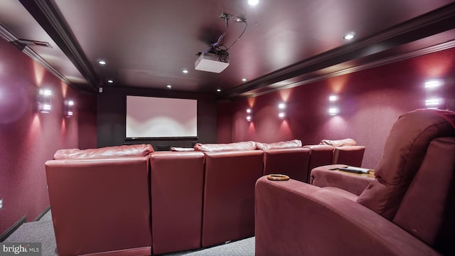 carpeted cinema room featuring ornamental molding