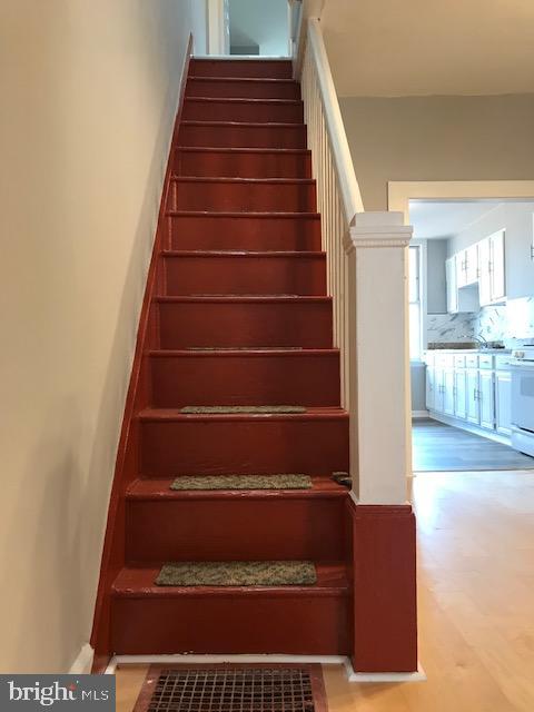 stairs with hardwood / wood-style flooring