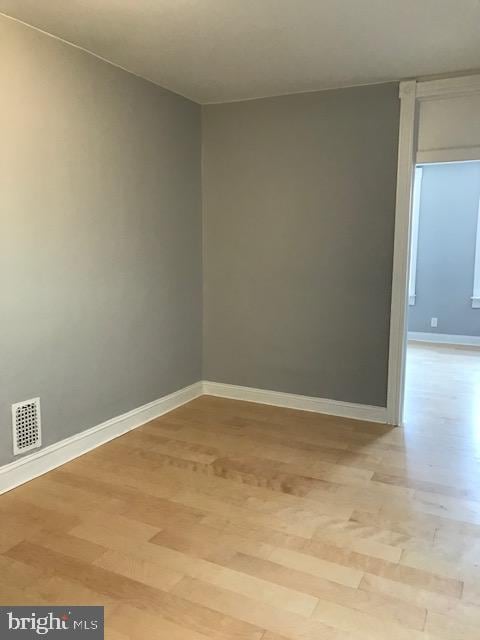 spare room with light wood-type flooring