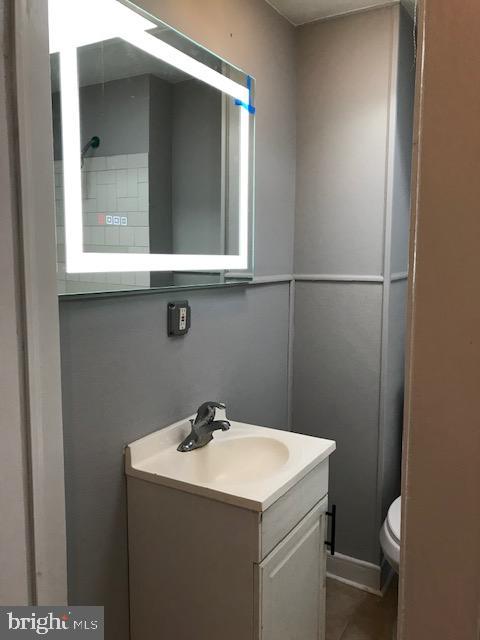 bathroom featuring vanity and toilet