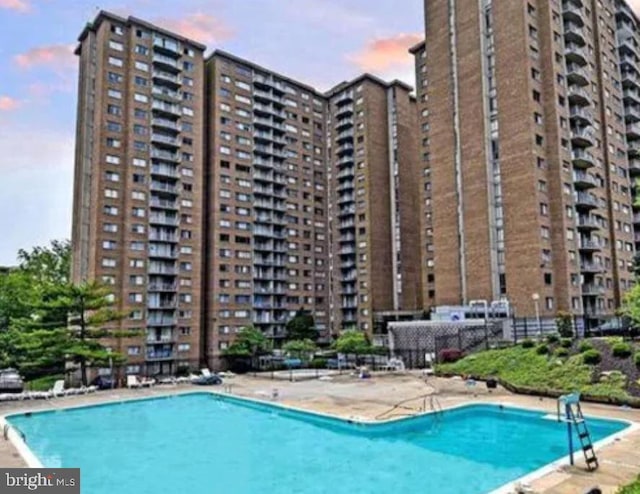 view of pool at dusk