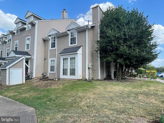 view of front of house featuring a front yard and a shed