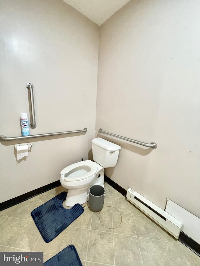 bathroom featuring tile patterned flooring, toilet, and baseboard heating