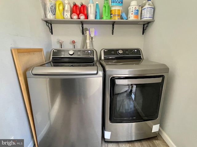 laundry room featuring washer and dryer and wood-type flooring