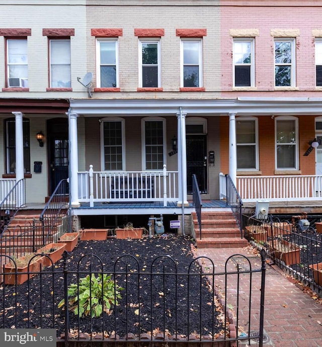 townhome / multi-family property featuring a porch