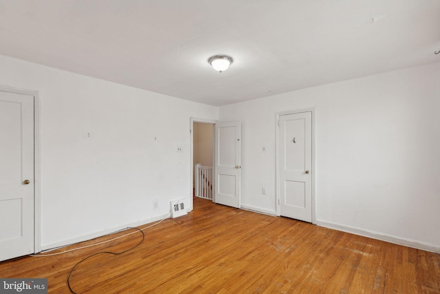 spare room featuring light hardwood / wood-style flooring