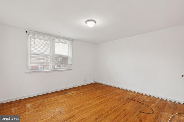 empty room with hardwood / wood-style flooring