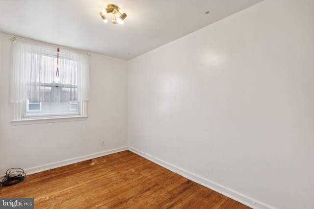 spare room with hardwood / wood-style flooring