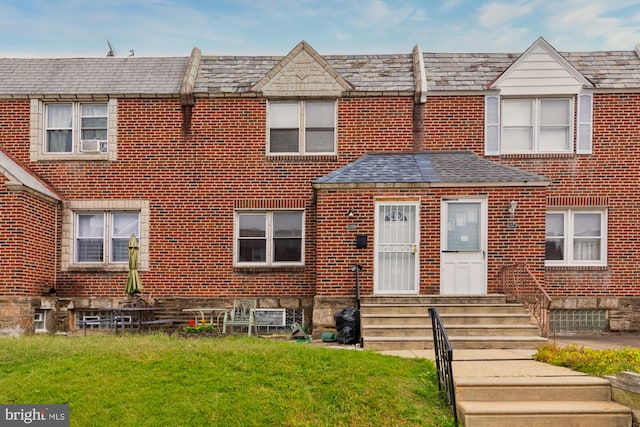 view of property with cooling unit and a front yard