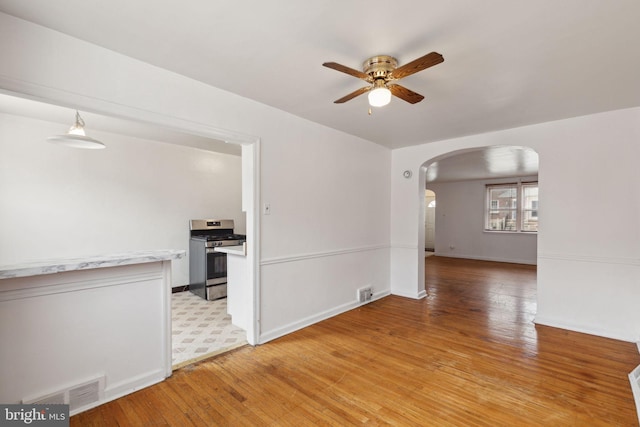 spare room featuring light hardwood / wood-style floors and ceiling fan