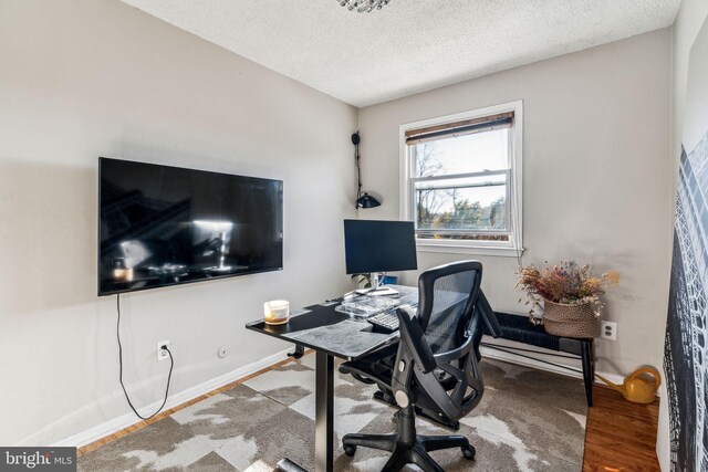 office space featuring a textured ceiling and hardwood / wood-style flooring