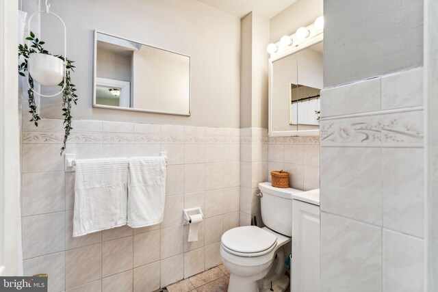 bathroom featuring tile walls, toilet, and tile patterned floors