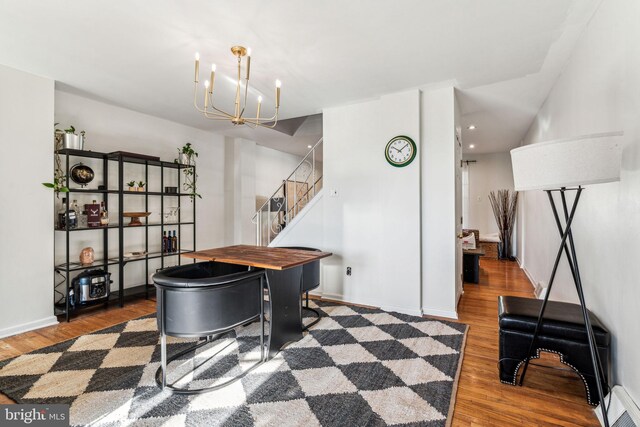 playroom featuring baseboard heating, a chandelier, and dark wood-type flooring