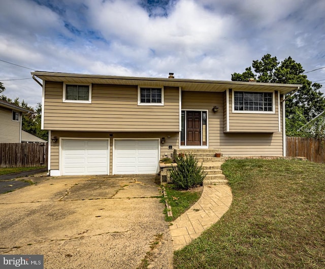 split foyer home with a garage and a front yard