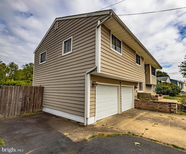 view of side of home with a garage