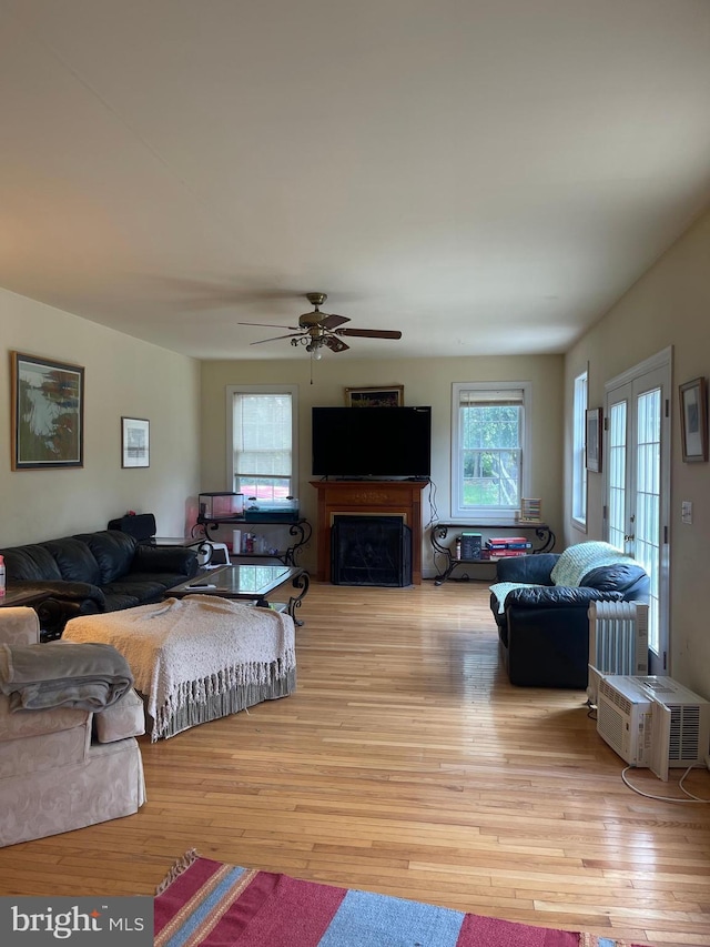 living room with french doors, light hardwood / wood-style flooring, and ceiling fan