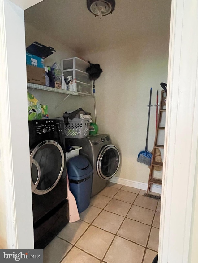 washroom featuring light tile patterned flooring and separate washer and dryer