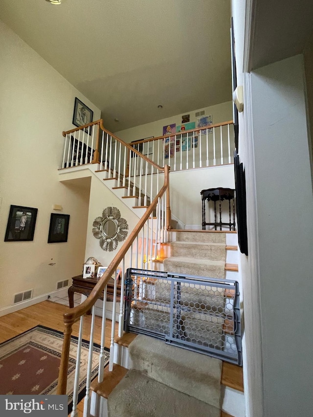 staircase with hardwood / wood-style floors