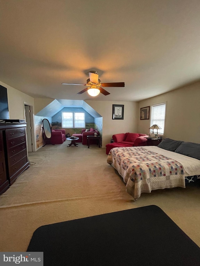 carpeted bedroom with vaulted ceiling and ceiling fan