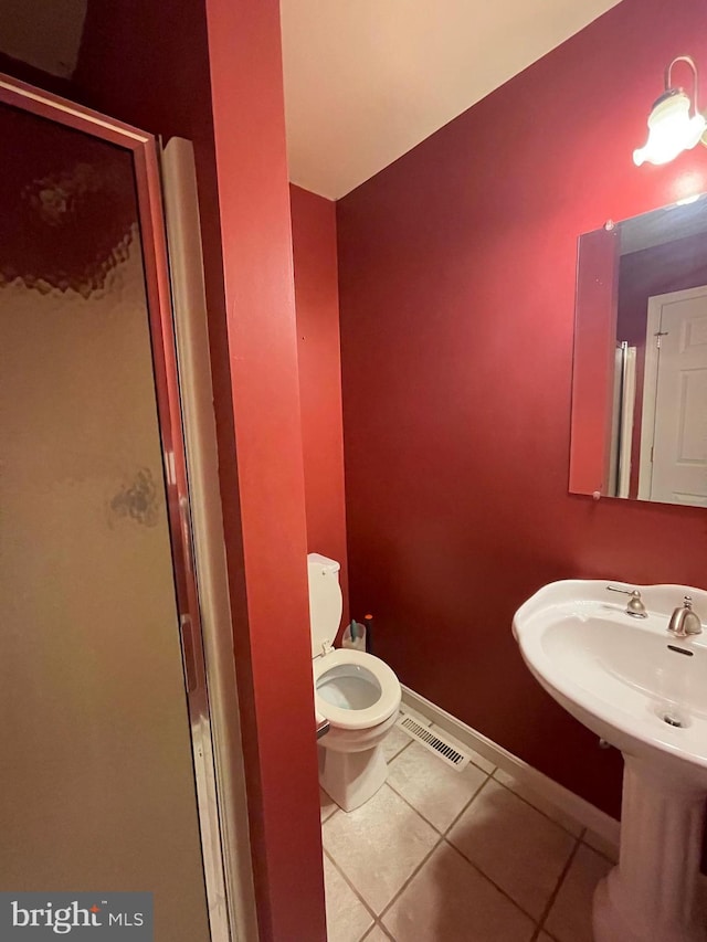 bathroom with tile patterned floors, sink, and toilet