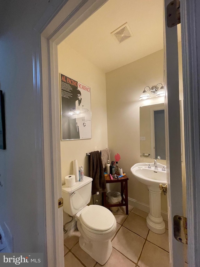 bathroom with toilet and tile patterned floors