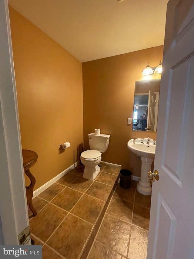 bathroom featuring toilet and tile patterned flooring