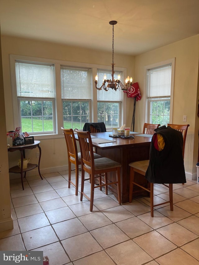 dining area featuring a chandelier, light tile patterned floors, and a wealth of natural light