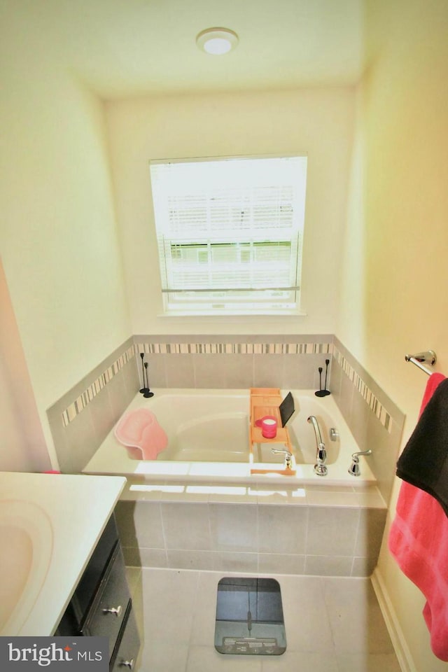 bathroom featuring vanity, tiled tub, and tile patterned floors