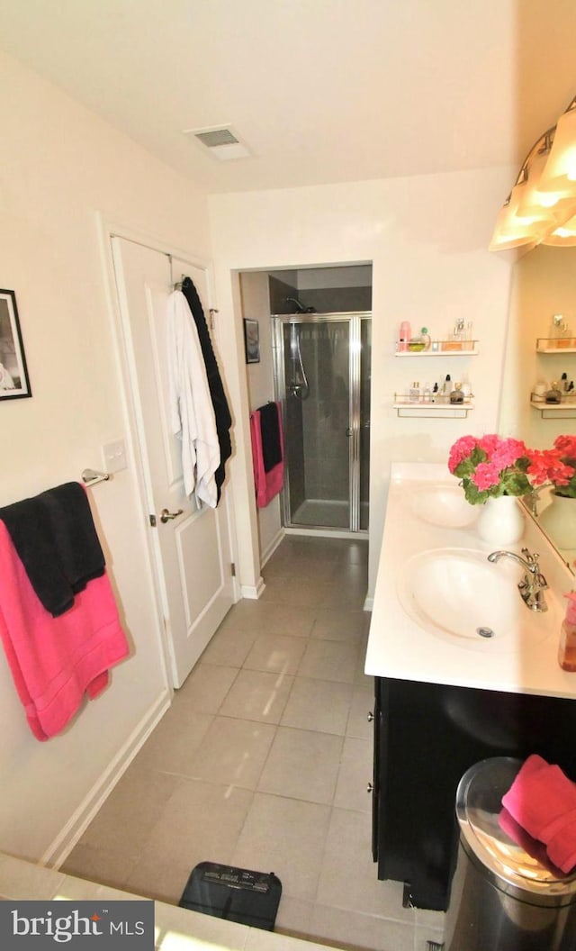 bathroom with vanity, tile patterned floors, and an enclosed shower