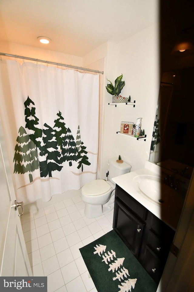 bathroom featuring vanity, a shower with shower curtain, toilet, and tile patterned flooring