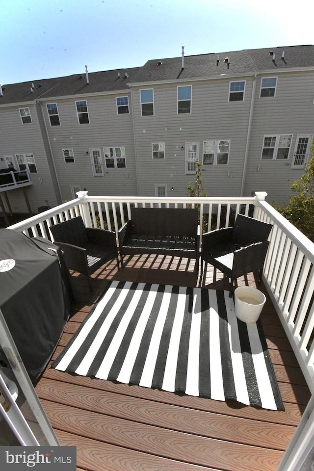 wooden terrace with a grill