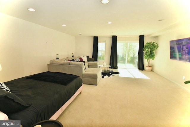 bedroom featuring access to outside and light colored carpet